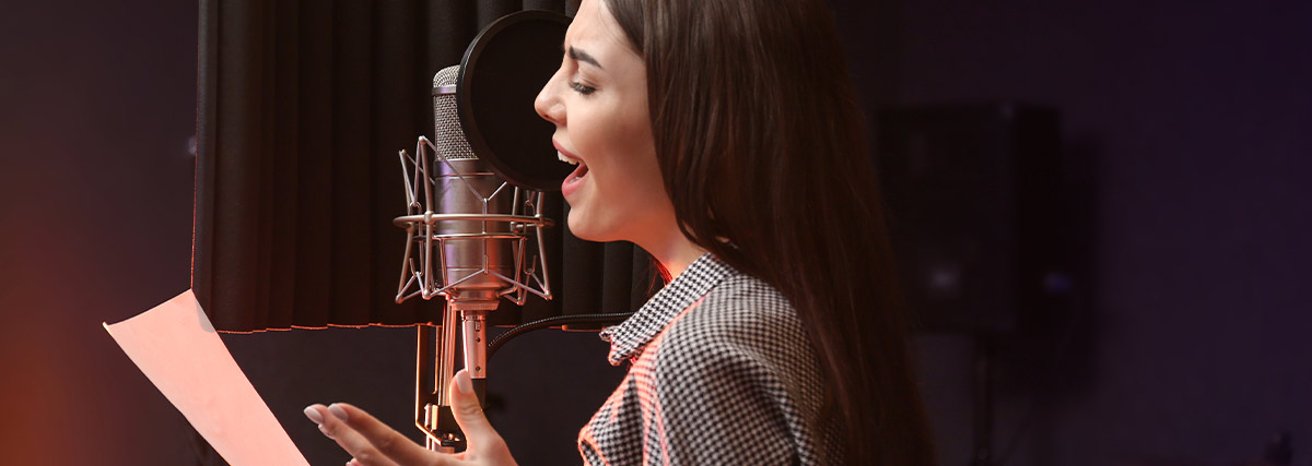 Adult singers recording together in a music studio with a vocal microphone