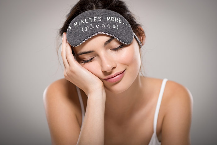 Beautiful woman sleeping wearing eye mask
