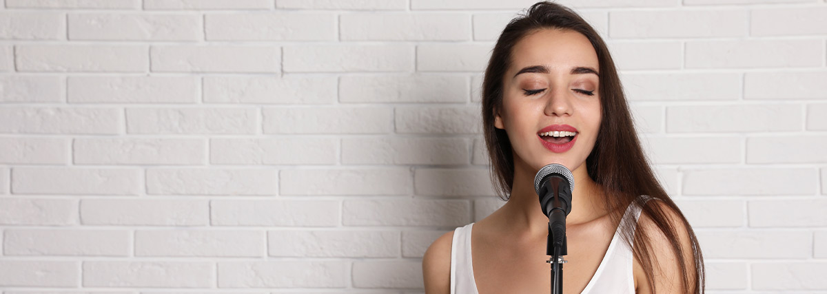 Beautiful woman standing and singing