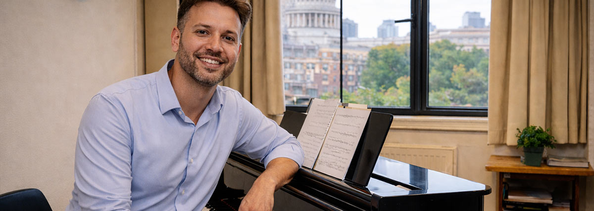 British music teacher smiling sitting by the piano