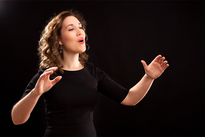 Female choir conductor during performance