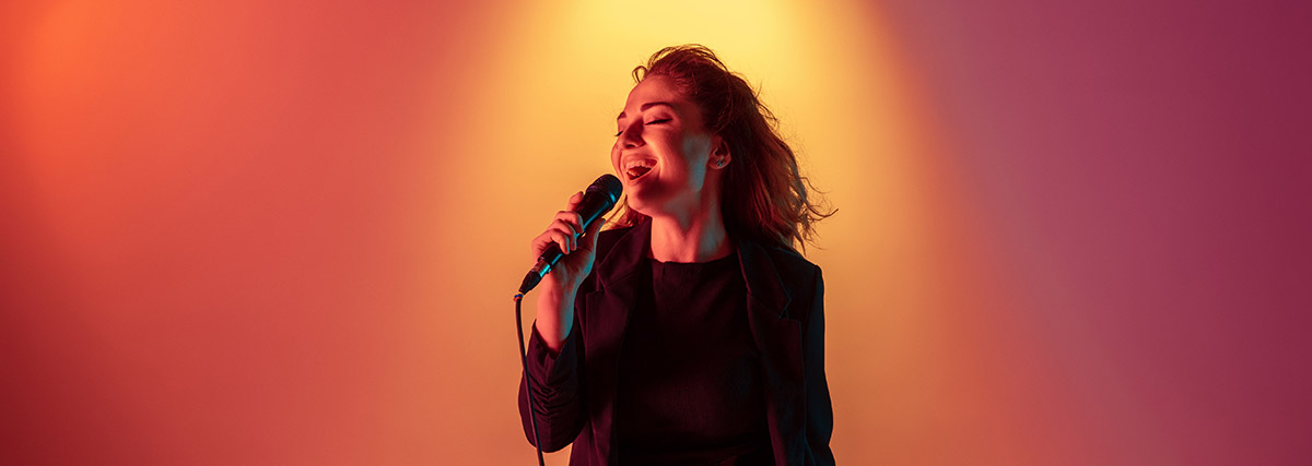 female performer singing onstage