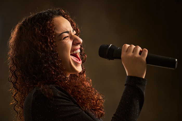 Female singer hitting high notes