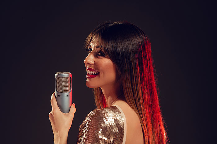 female singer in gold dress feat