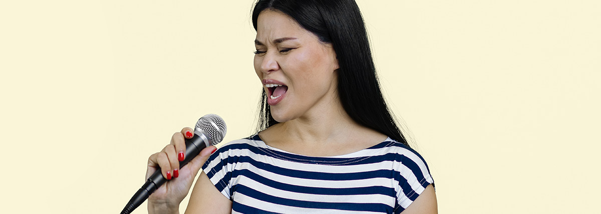 Female singer performing with a microphone during a vocal training session