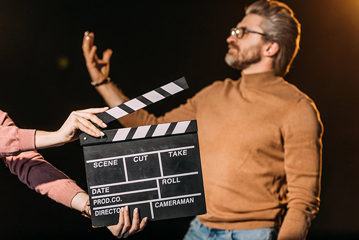 Film scene clapperboard with actor in background