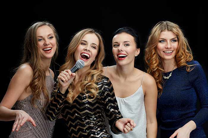 Ladies singing together in a group format