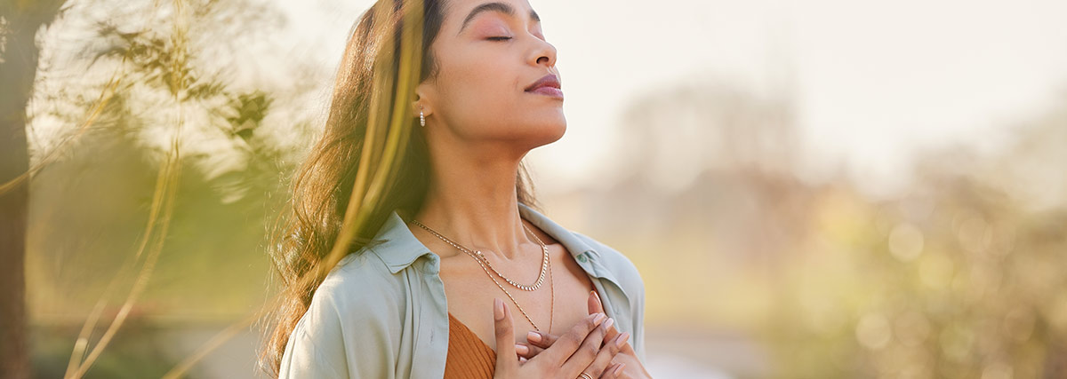 Lady breathing deeply by closing eyes
