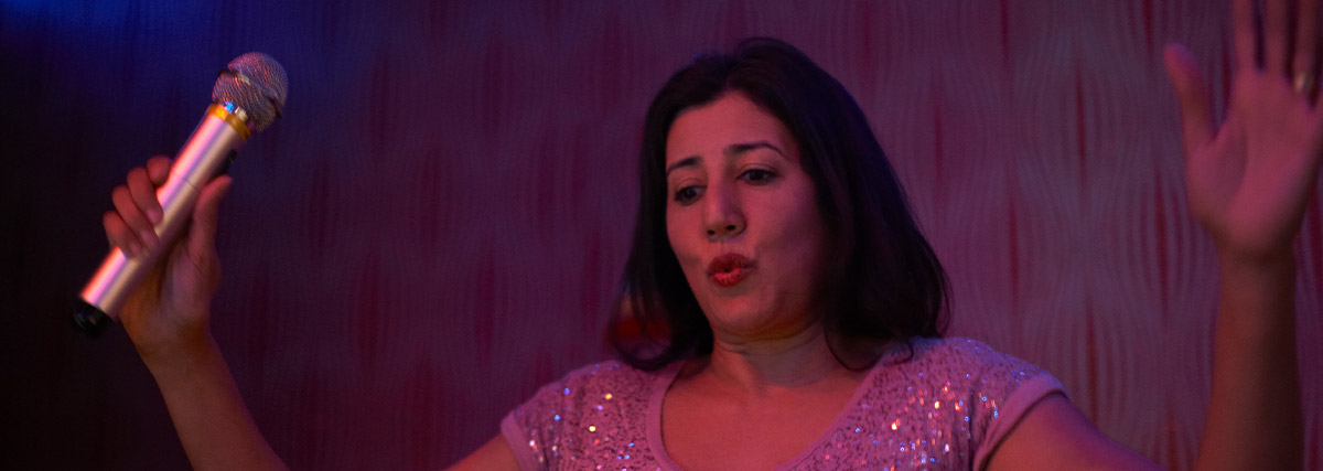 Lady folding lips by holding microphone