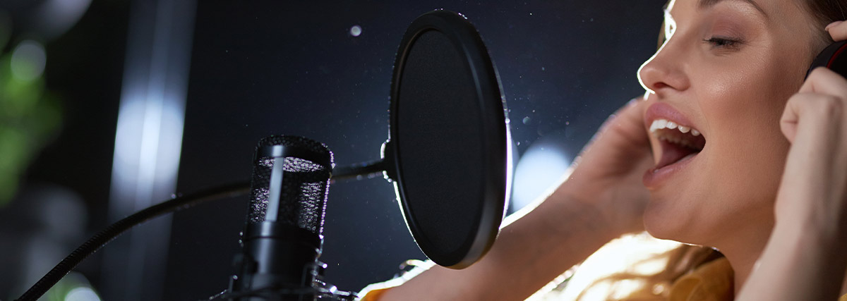 Lady singing in studio