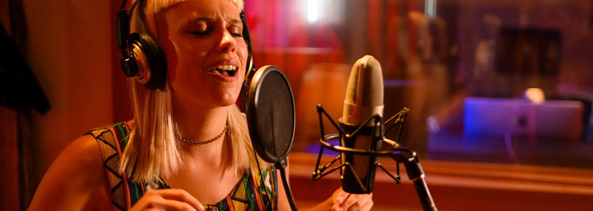 Lady singing in studio