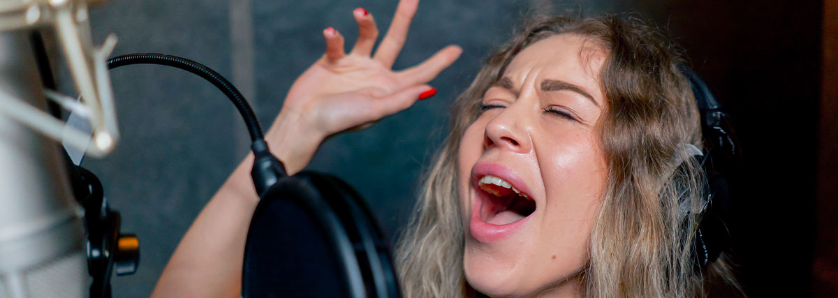 Lady singing loudly in studio