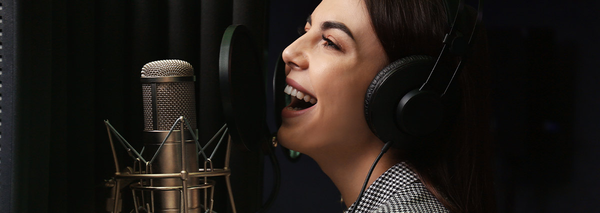 Lady with headphone smiling and singing
