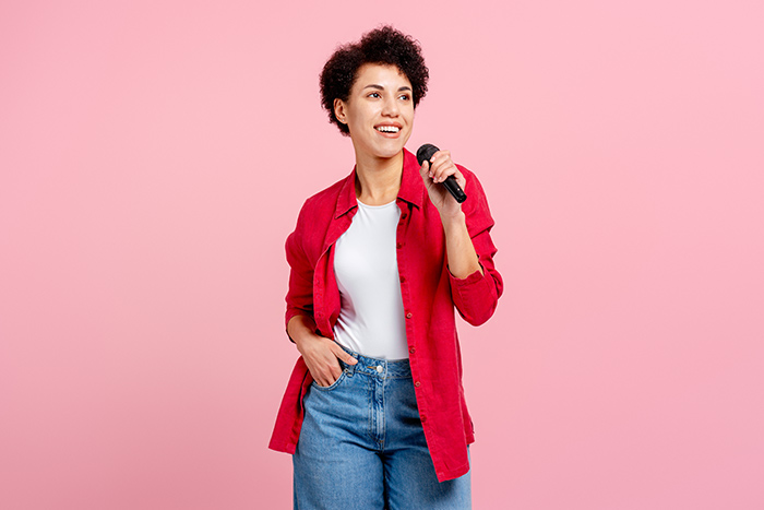 Lady with red shirt holding microphone