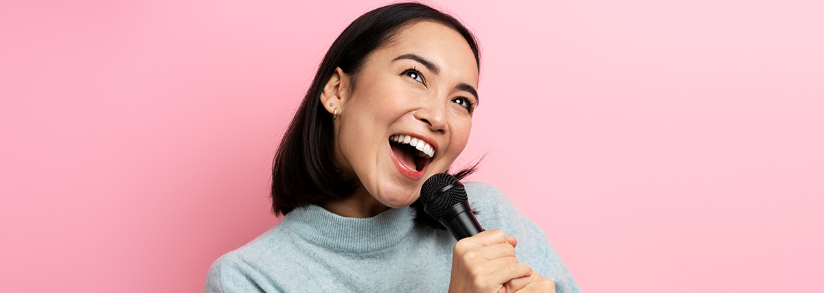 Lady with short hair singing with microphone