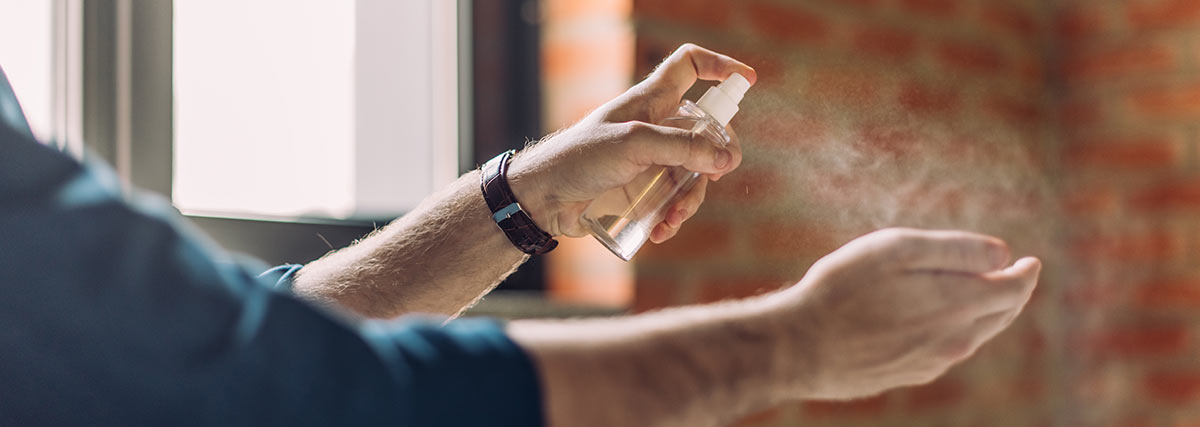 man sanitizing his hands