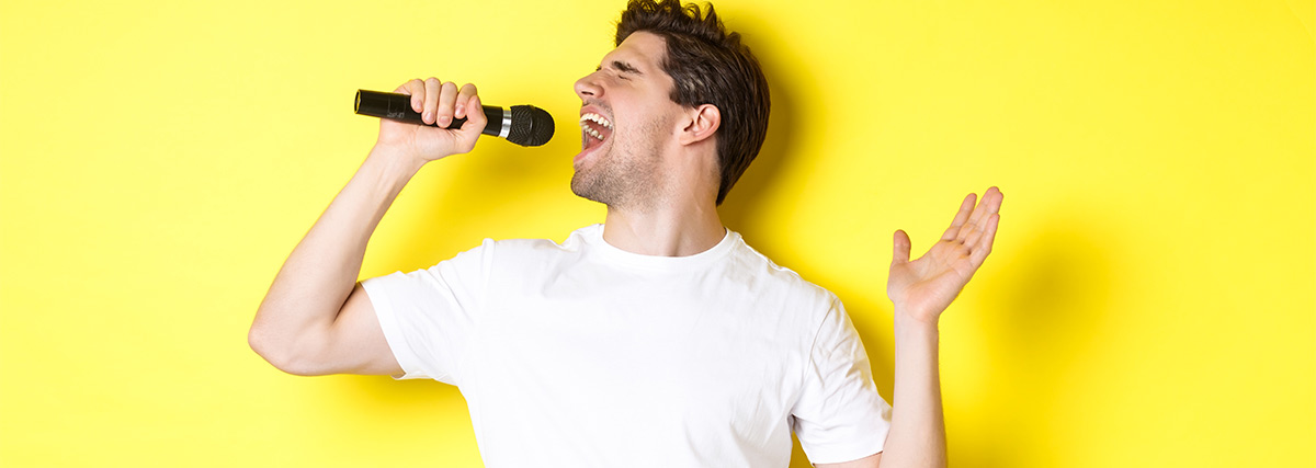 Man singing high notes against yellow background