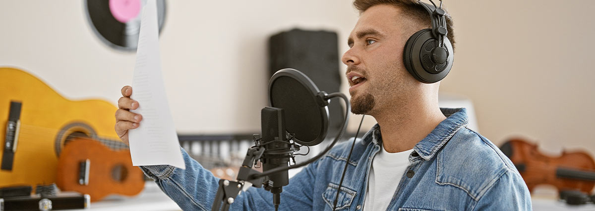 Man singing holding music sheet