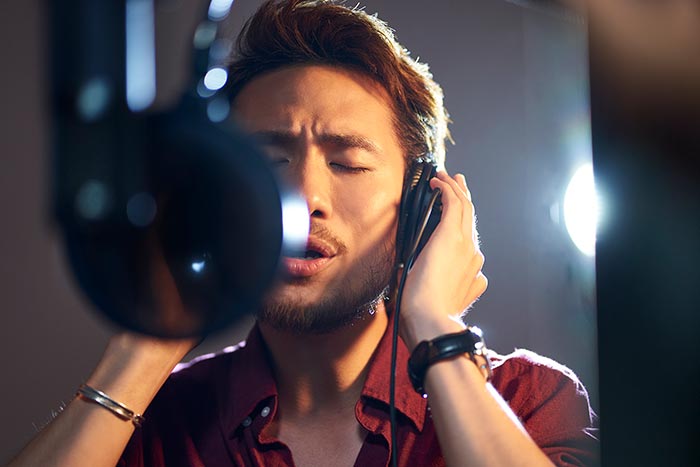 man singing with microphone feat