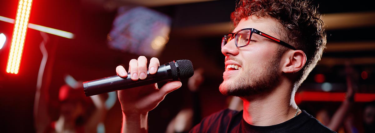 Man wearing eyeglasses singing