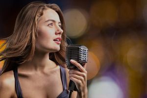 Lady singing in a microphone