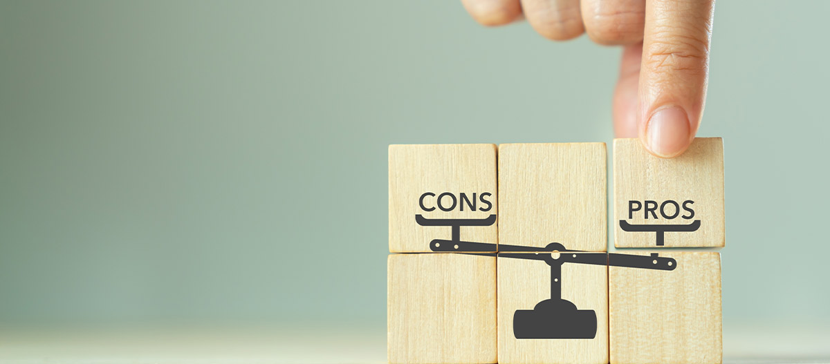 Point finger pointing at pros and cons blocks