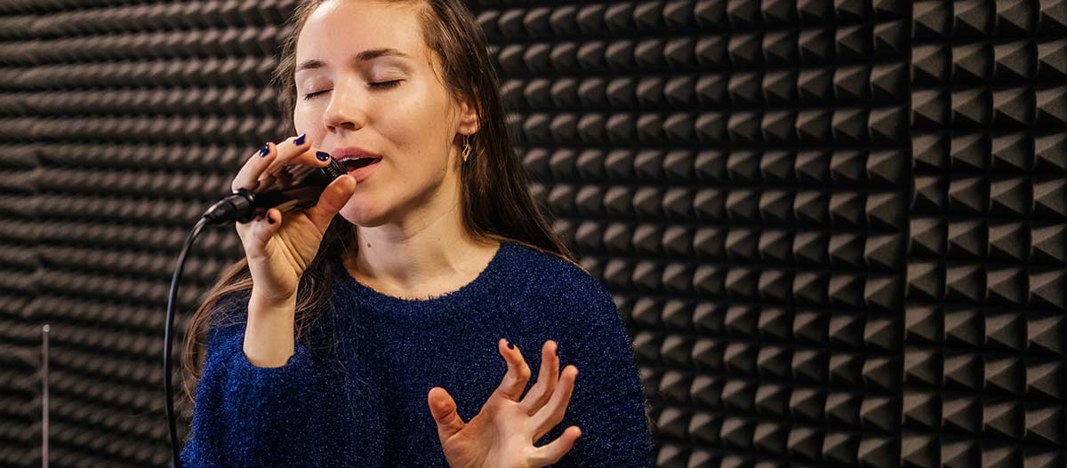 Simple woman singing in studio