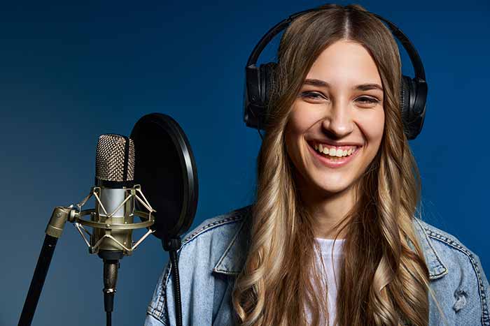 singer in studio smiling feat