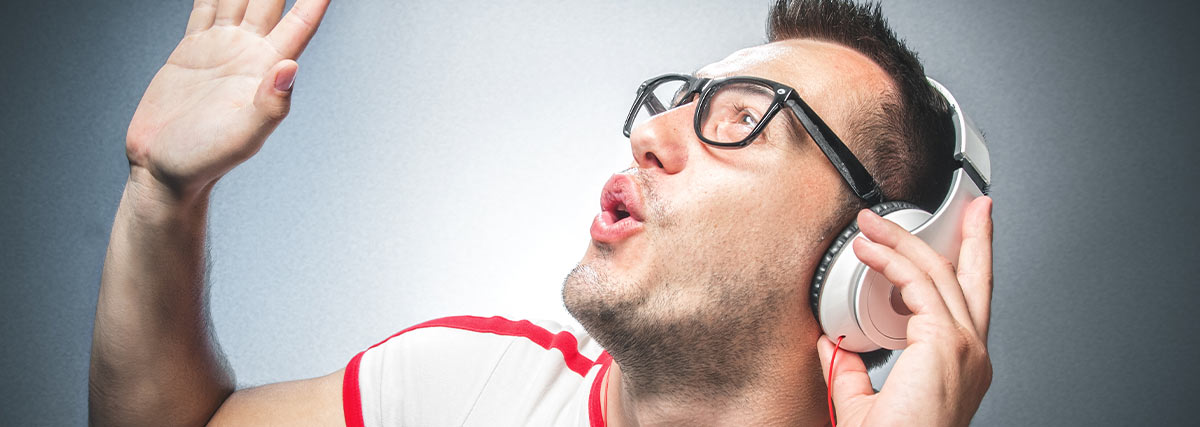 Singer listening through headphones and practising internal pitch awareness