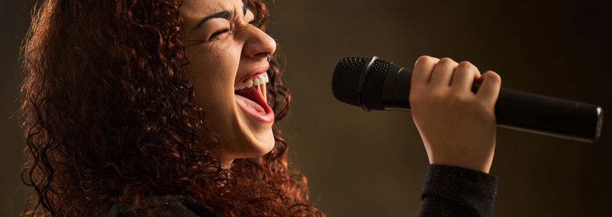Singer with curl hair hitting high note