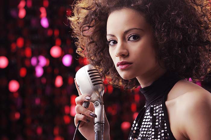 singer with mic on stage feat