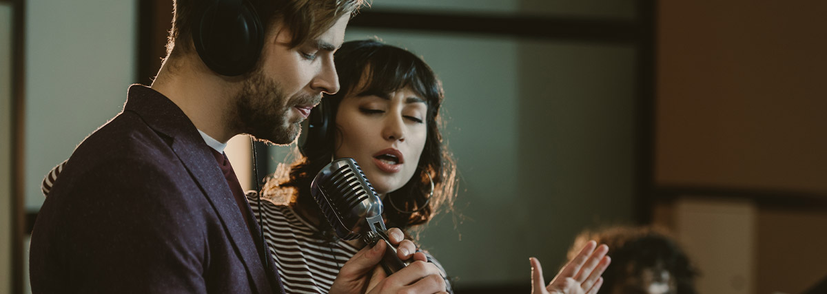 Singing student practising with a keyboard and studio microphone