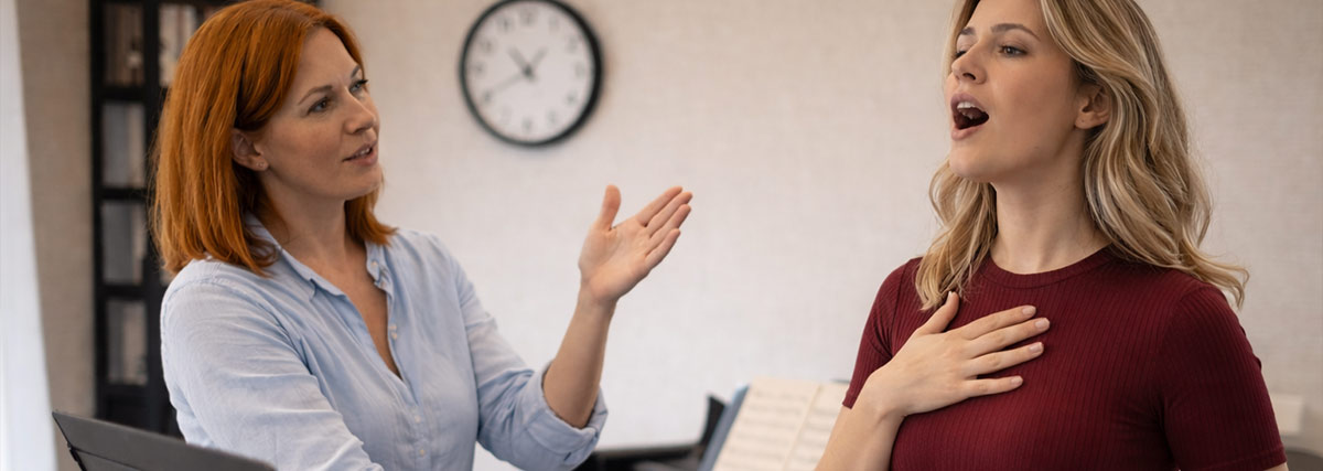 Singing teacher and student having lesson