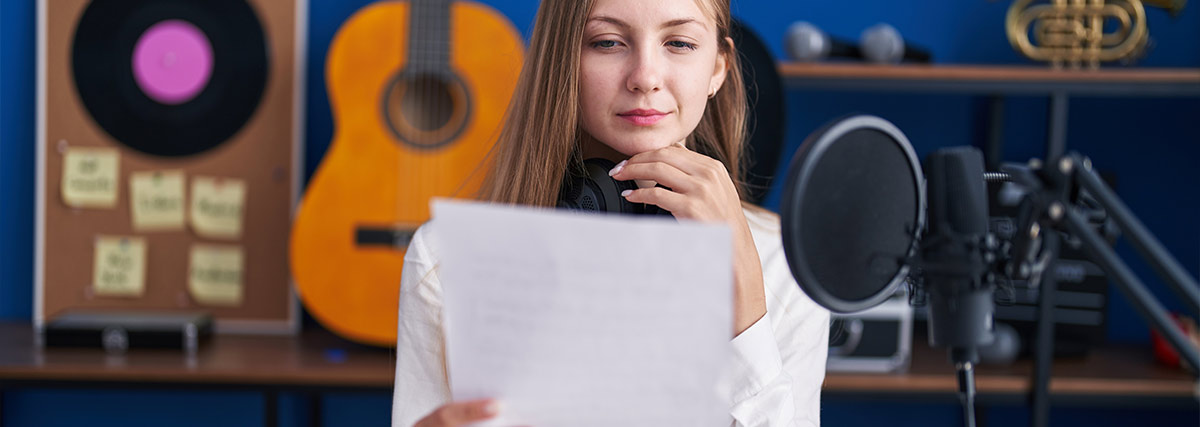 Woman in the music studio holding a paper