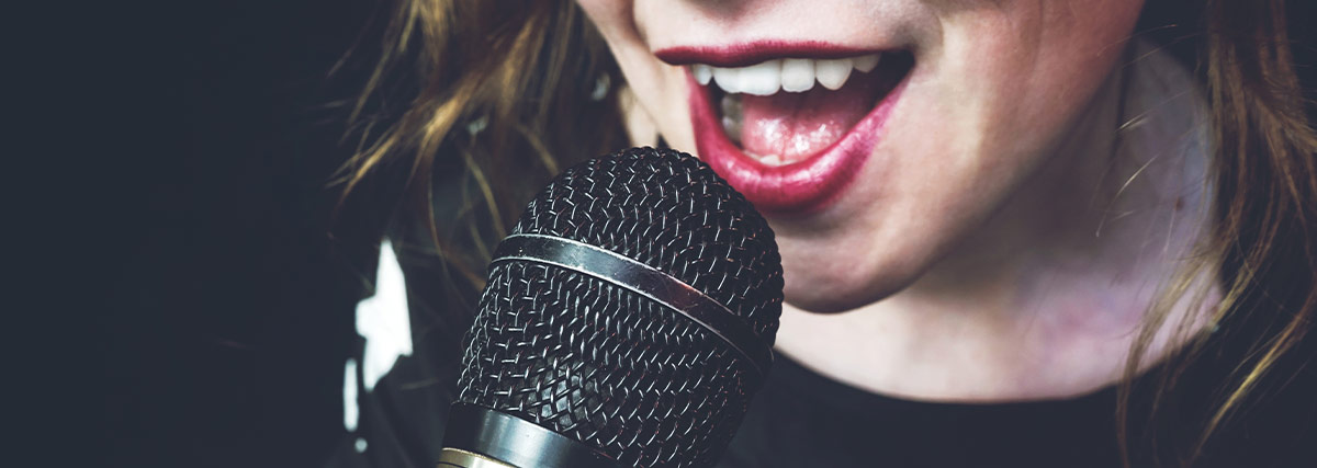 Woman mouth with red lipstick singing