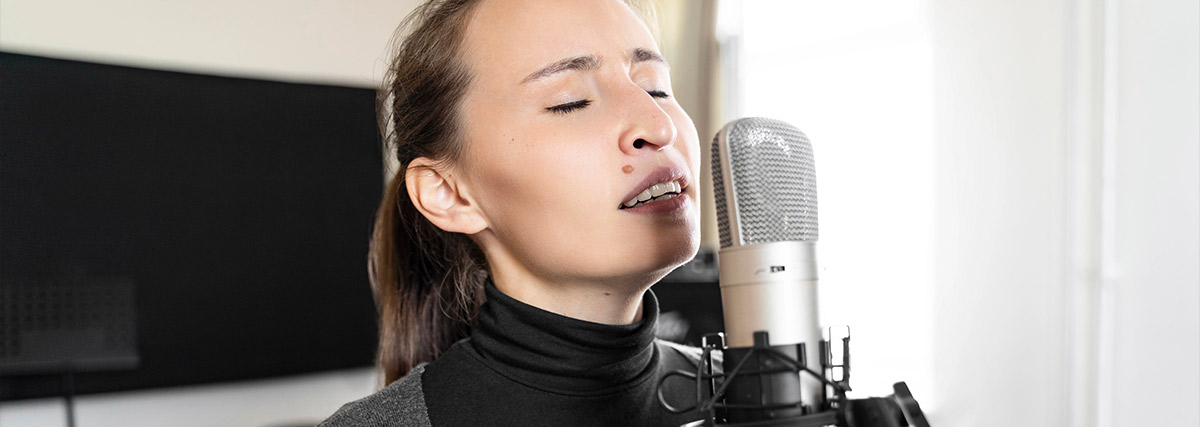 Woman practising singing at home