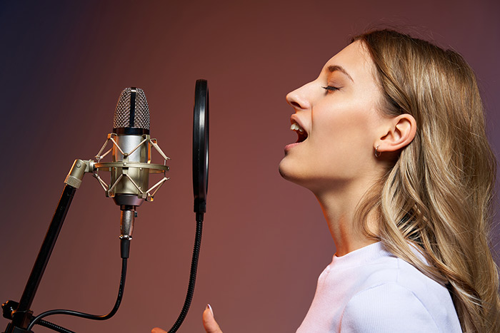 Woman singing in studio