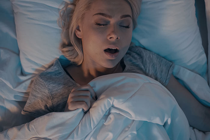 woman sleeping in bed feat