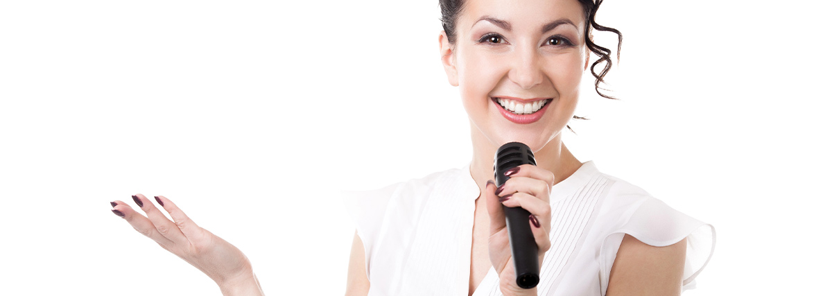 Woman smiling holding a microphone against white background