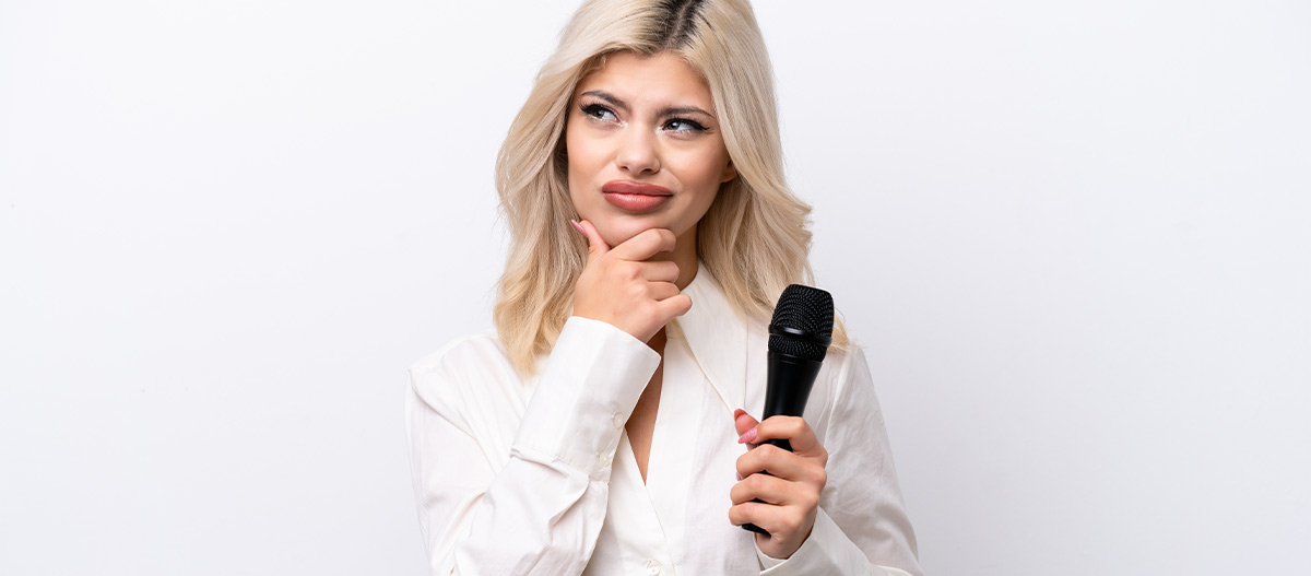 Woman thinking and holding a microphone