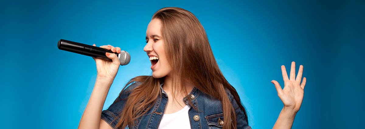 woman with blue background singing