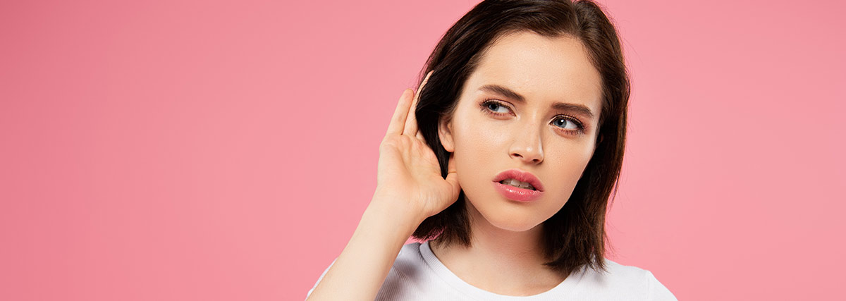 woman with on hand on her ear