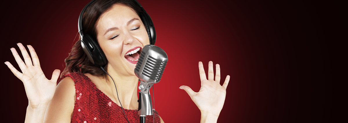 Woman with headphone and red dress singing