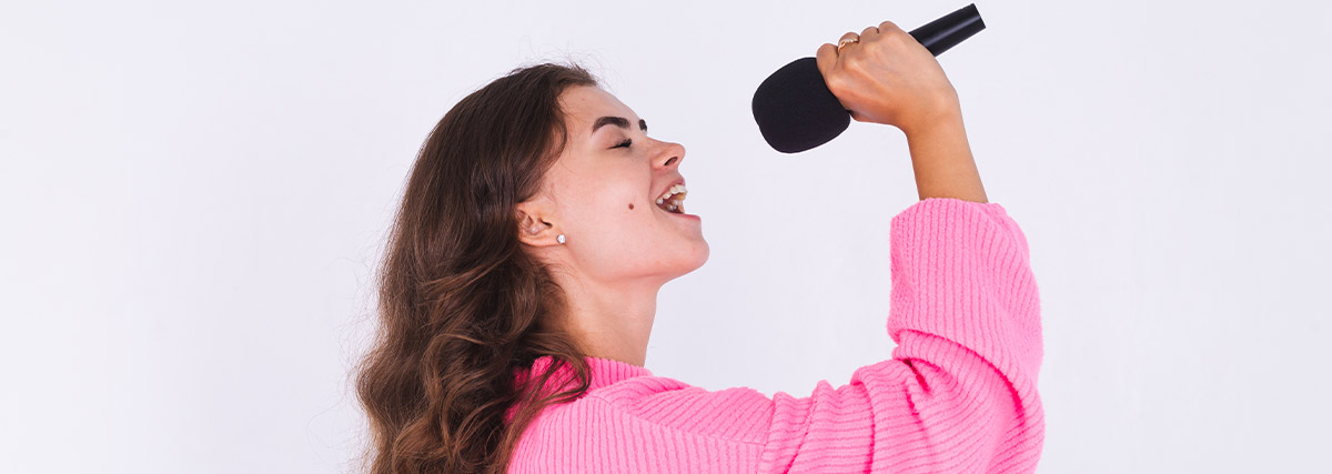 Woman with pink blouse singing