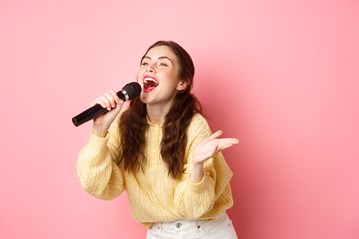 Woman with yellow blouse singing
