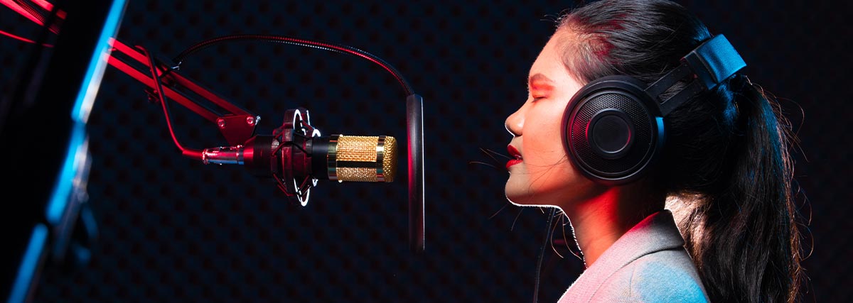 Young woman singing in the studio